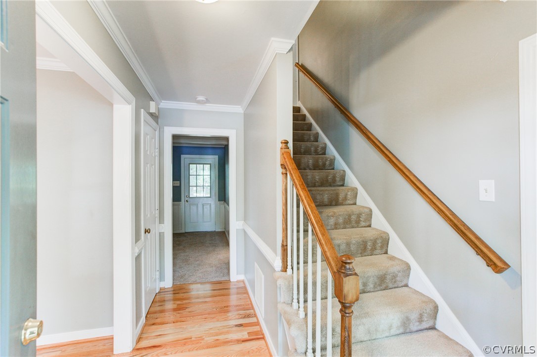 703 Fennimore Road Midlothian, VA 23114 - Photo 3 of 22 a view of a hallway with wooden floor and entryway