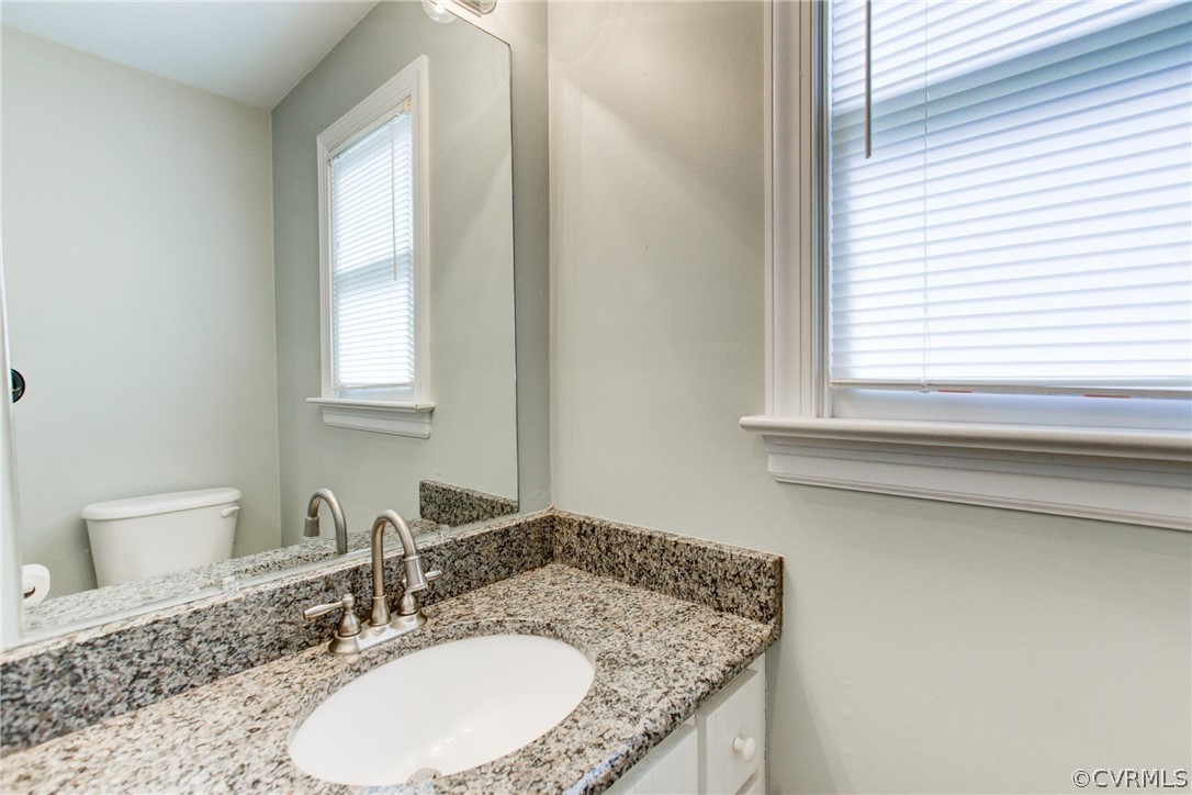 703 Fennimore Road Midlothian, VA 23114 - Photo 6 of 22 a bathroom with a granite countertop sink and a mirror