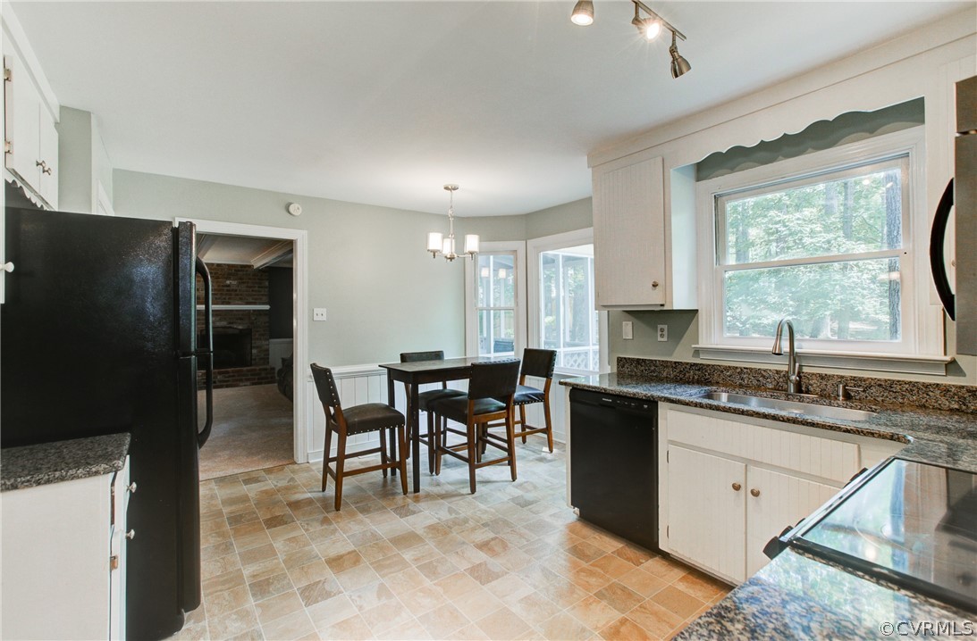 703 Fennimore Road Midlothian, VA 23114 - Photo 8 of 22 a kitchen with granite countertop a sink cabinets and stainless steel appliances