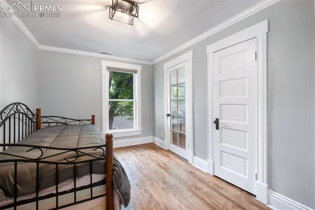 a bedroom with furniture window and wooden floor