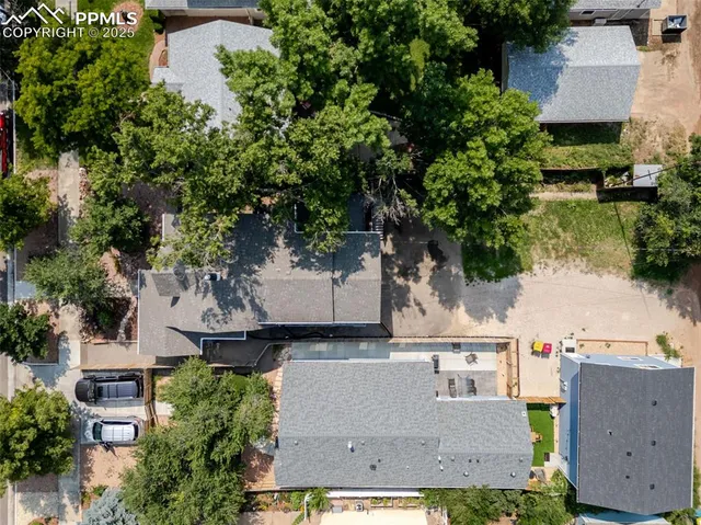 an aerial view of residential houses with outdoor space and parking
