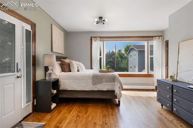 a bed sitting in a bedroom next to a window