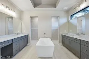 a spacious bathroom with a double vanity sink mirror and double