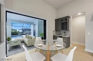 a dining room with furniture and a floor to ceiling window