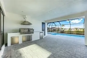 a open kitchen with a stove a sink and a refrigerator