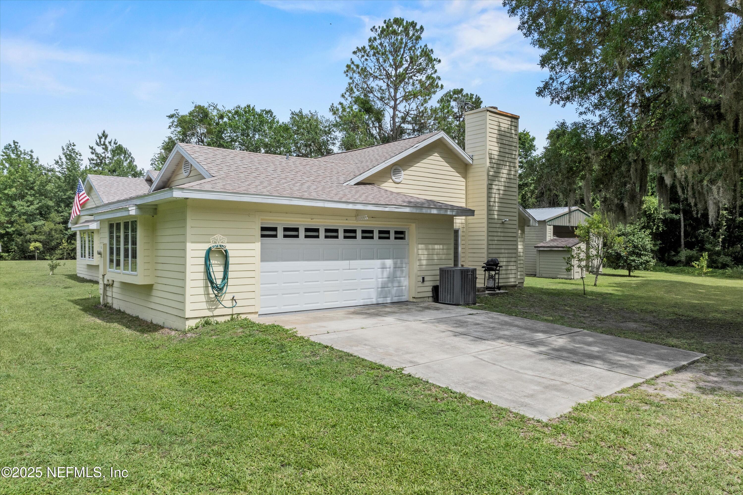 7720 Riverdale Road St. Augustine, FL 32092 - Photo 11 of 60 a front view of a house with a yard and garage