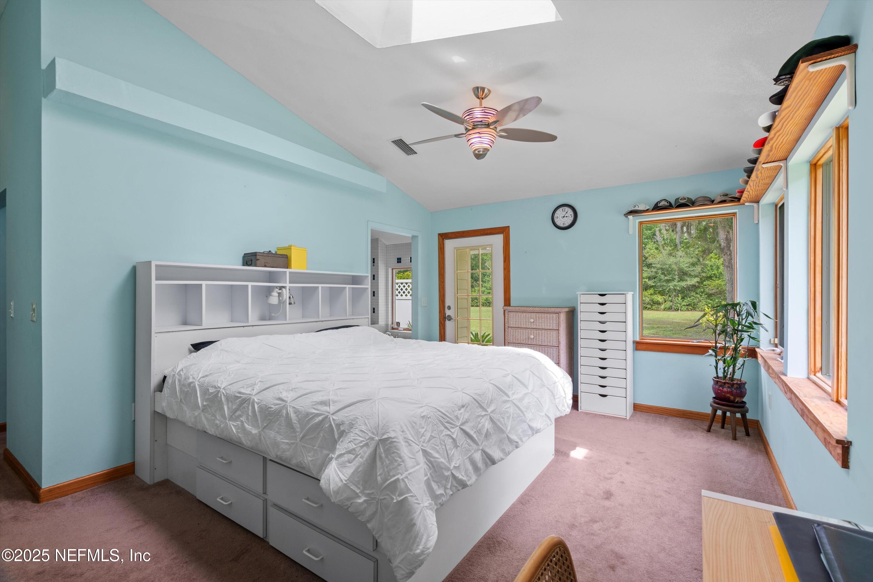 7720 Riverdale Road St. Augustine, FL 32092 - Photo 26 of 60 a bedroom with a large bed and a chandelier