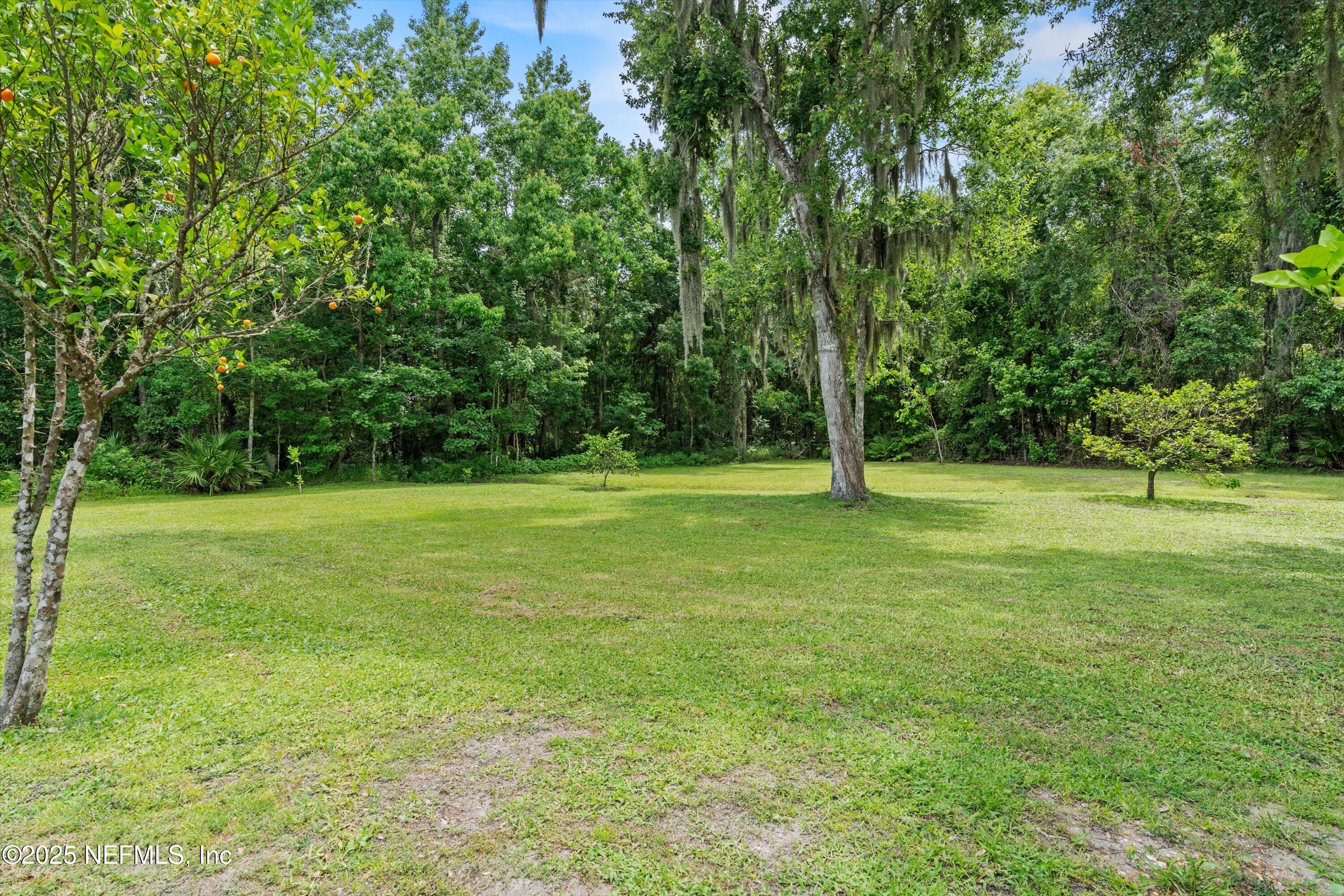 7720 Riverdale Road St. Augustine, FL 32092 - Photo 42 of 60 a view of outdoor space with deck and yard