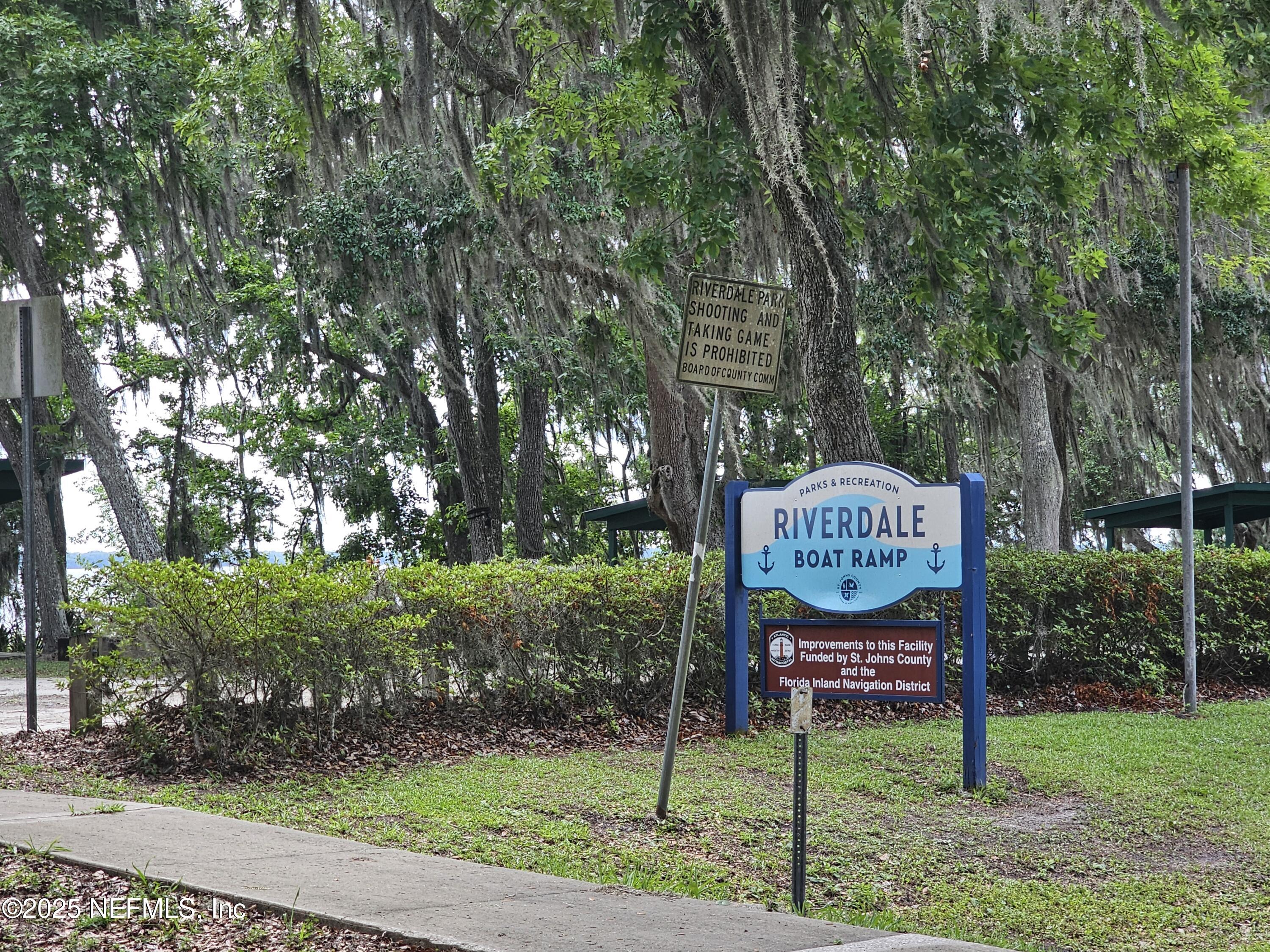7720 Riverdale Road St. Augustine, FL 32092 - Photo 46 of 60 a sign board with tall trees