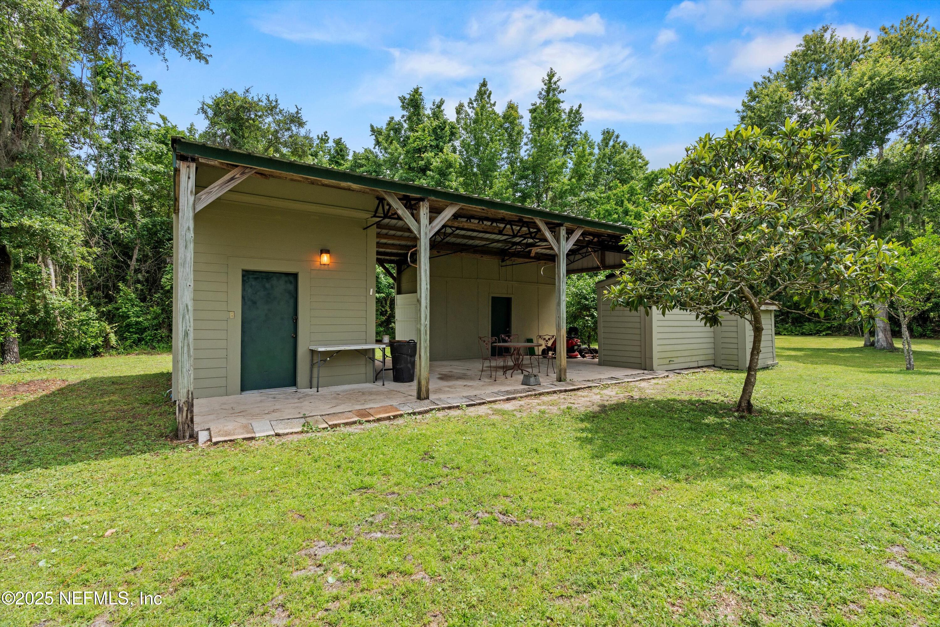 7720 Riverdale Road St. Augustine, FL 32092 - Photo 5 of 60 a view of a house with a yard and sitting area