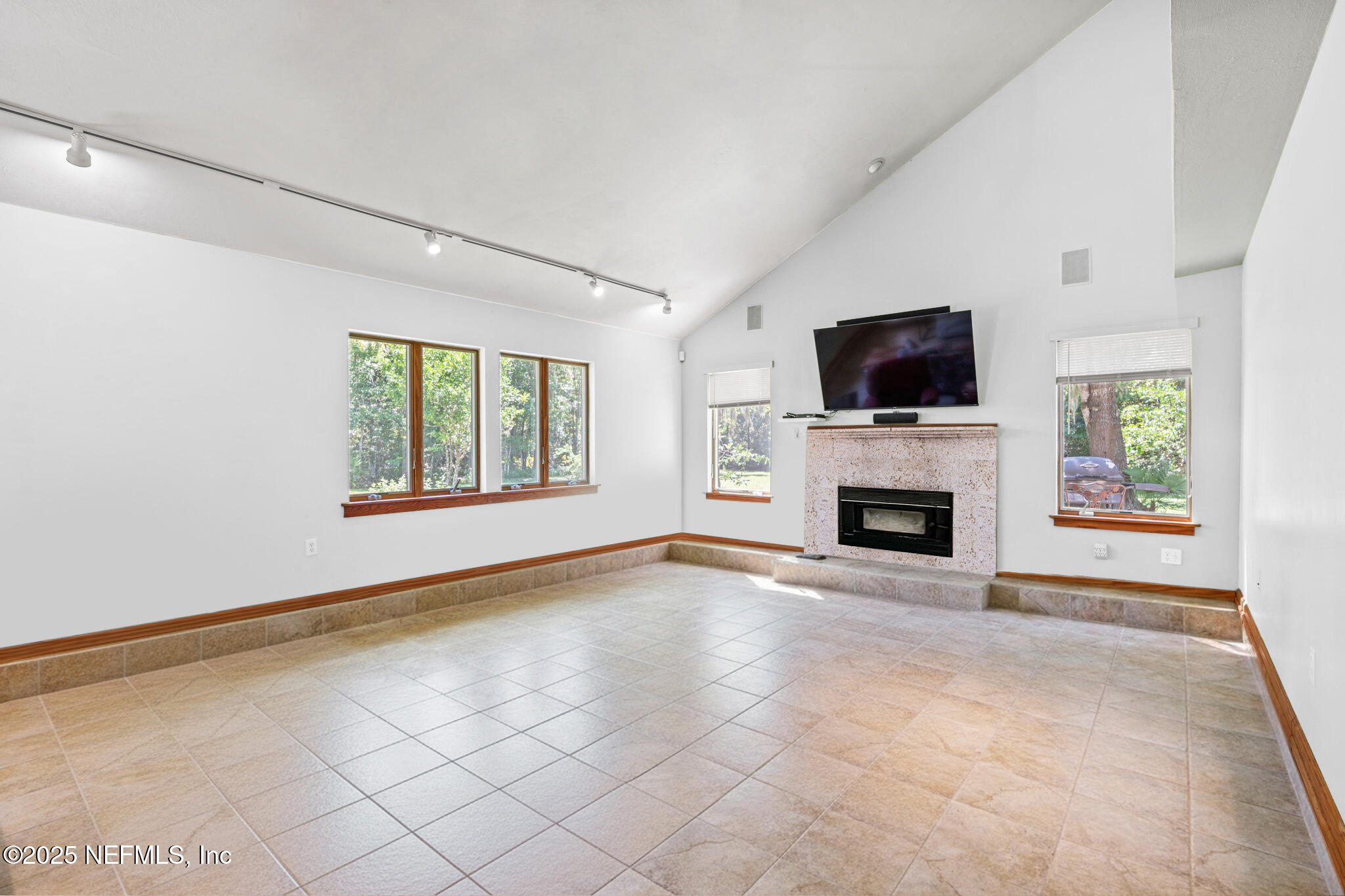 7720 Riverdale Road St. Augustine, FL 32092 - Photo 7 of 60 a view of an empty room with a fireplace and a window