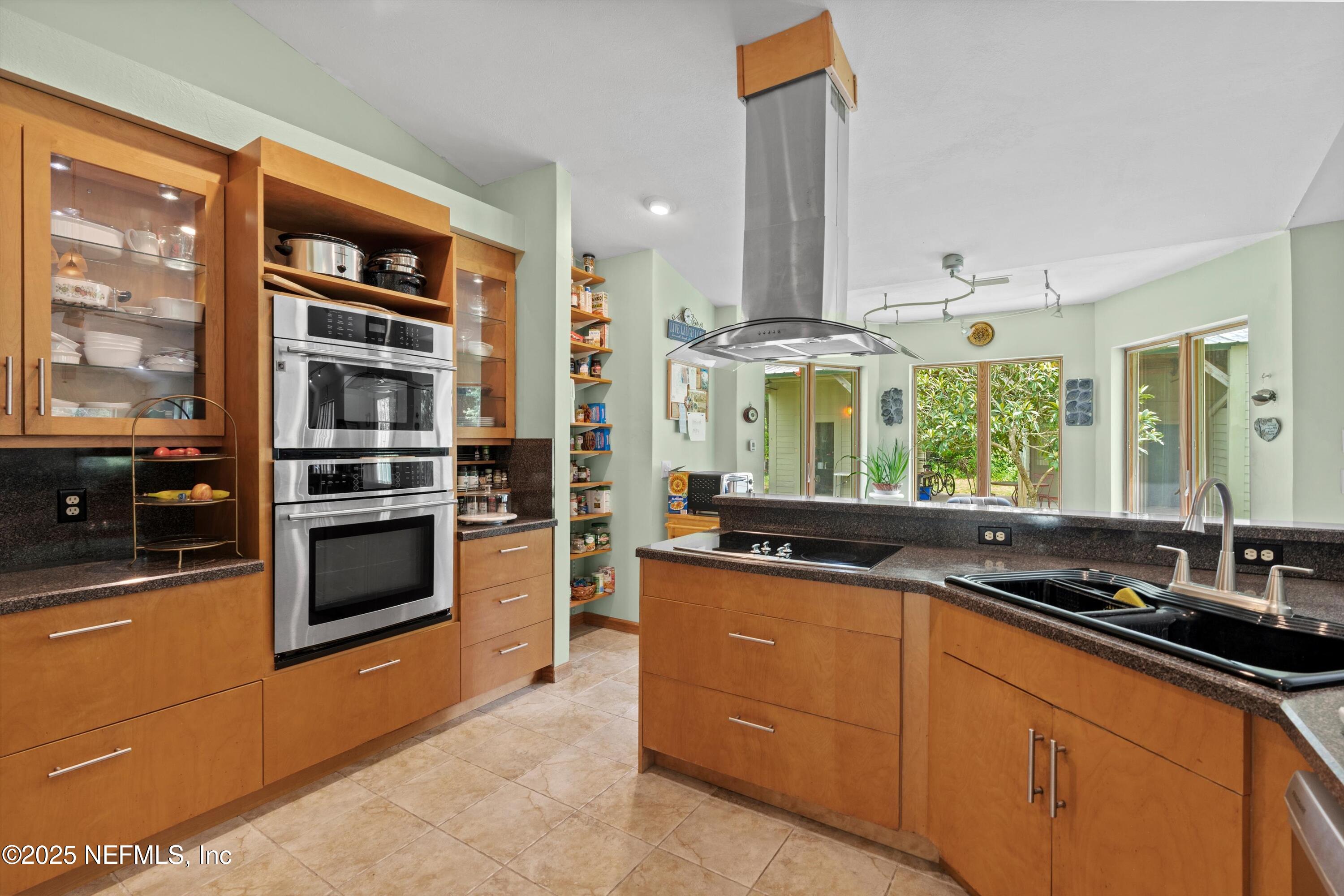 7720 Riverdale Road St. Augustine, FL 32092 - Photo 10 of 60 a kitchen with stainless steel appliances granite countertop a stove and a sink