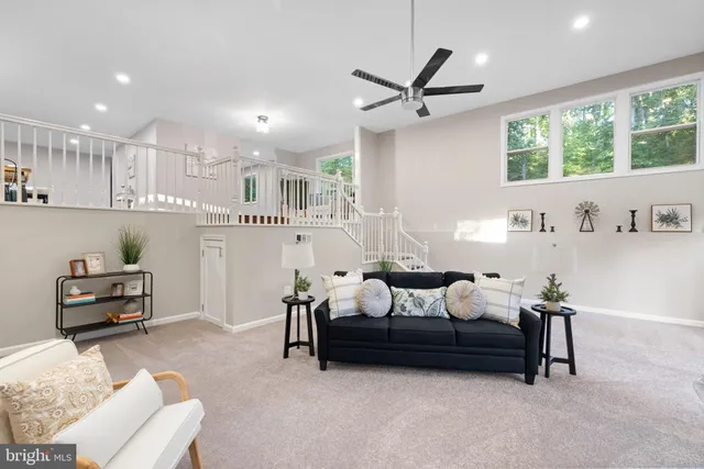 a bedroom with furniture and a large window