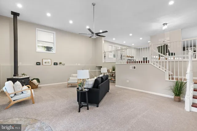 a living room with furniture and a ceiling fan