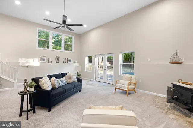 a living room with furniture ceiling fan and a rug