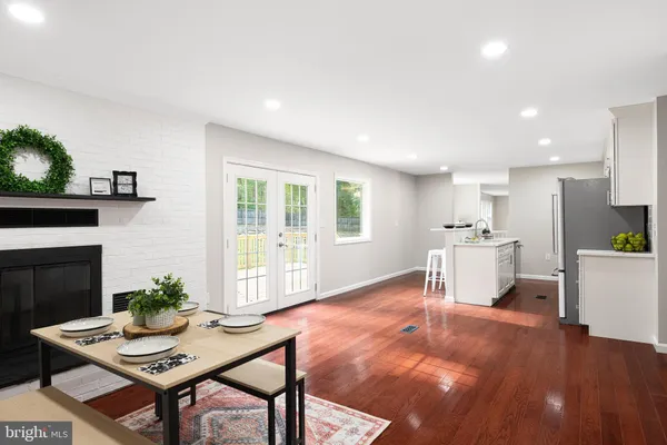 a living room with furniture a fireplace and a table