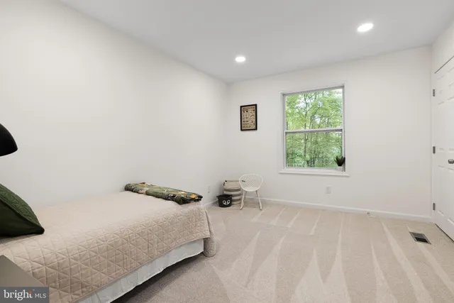 a bathroom with a sink a toilet and a large mirror