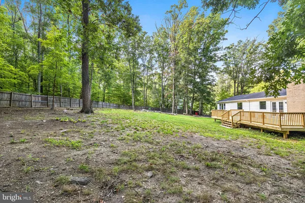 a view of a house with backyard and trees