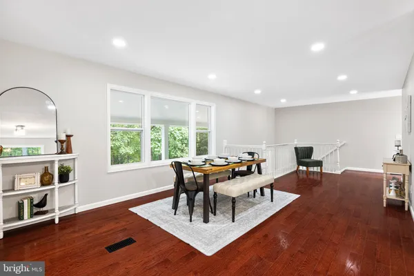 a living room with dining room and wooden floor