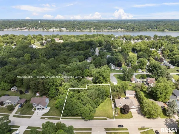 an aerial view of residential houses with outdoor space and ocean view
