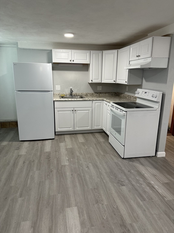 a white refrigerator freezer sitting inside of a kitchen