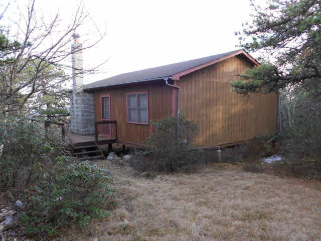 6 Kile Knob Road Franklin, WV 26807 - Photo 3 of 7 a backyard of a house with large trees and wooden fence
