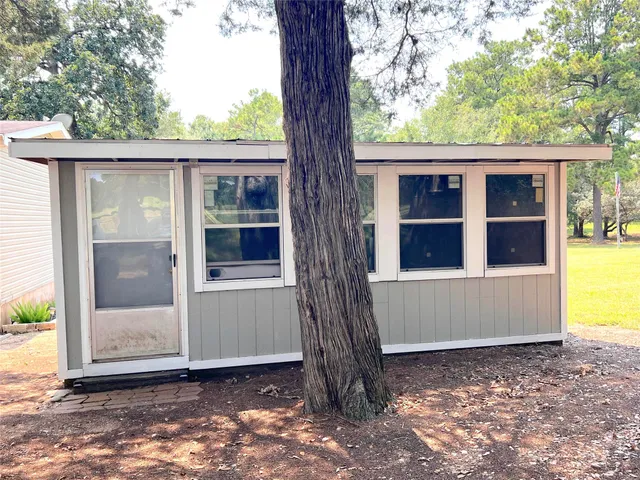 a view of a house with backyard and sitting area