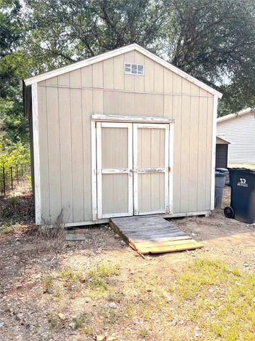 a view of backyard with swimming pool and seating space