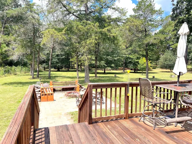 a view of a swimming pool with patio and backyard