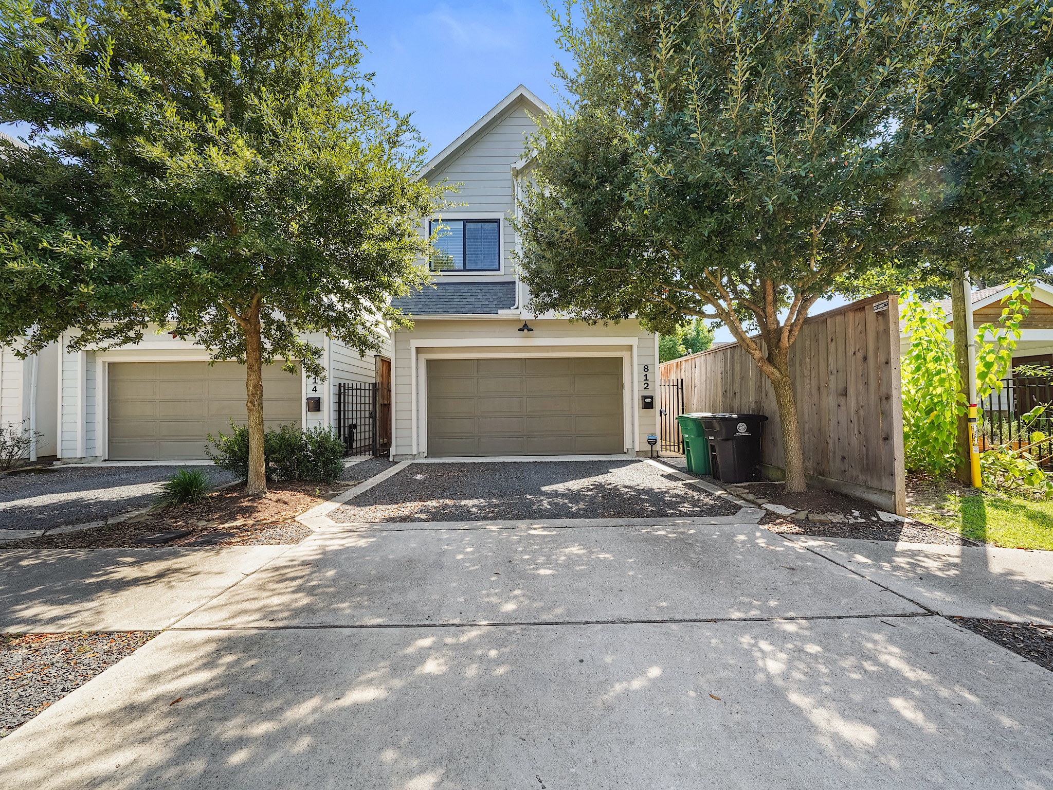 a view of a house with a yard and large tree