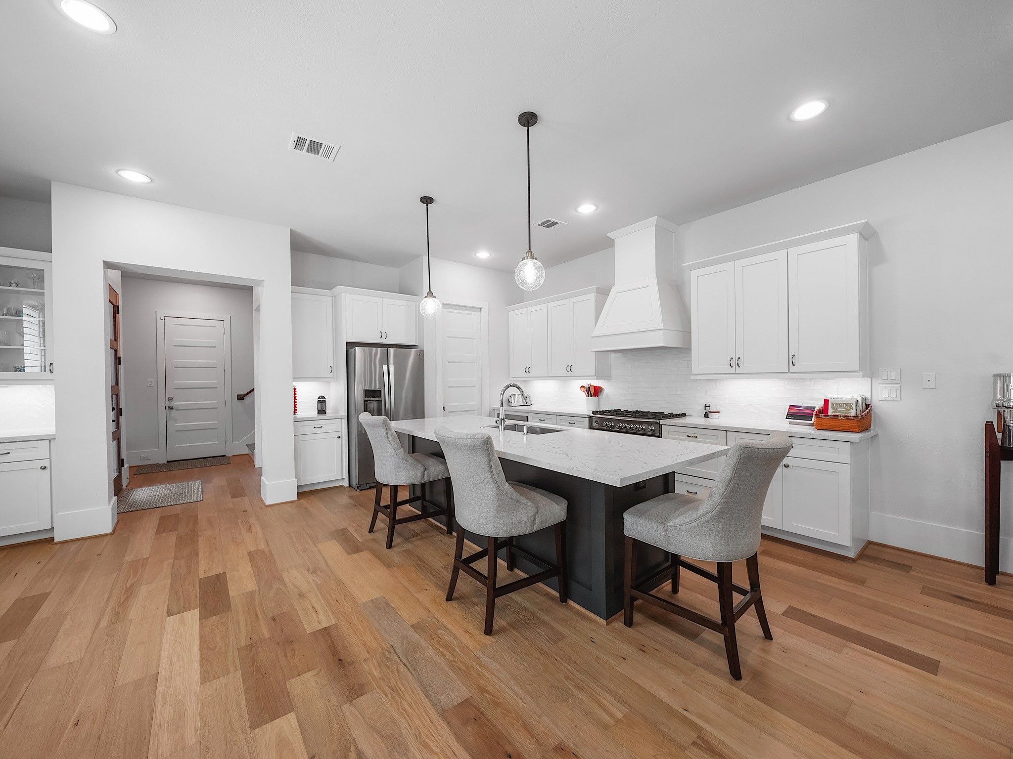 812 East 24th Street Houston, TX 77009 - Photo 11 of 36 a kitchen with stainless steel appliances a dining table chairs and wooden floor
