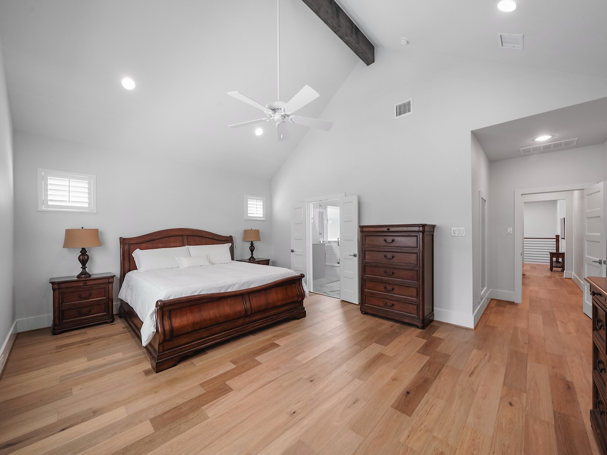 812 East 24th Street Houston, TX 77009 - Photo 22 of 36 a spacious bedroom with a bed and a chandelier