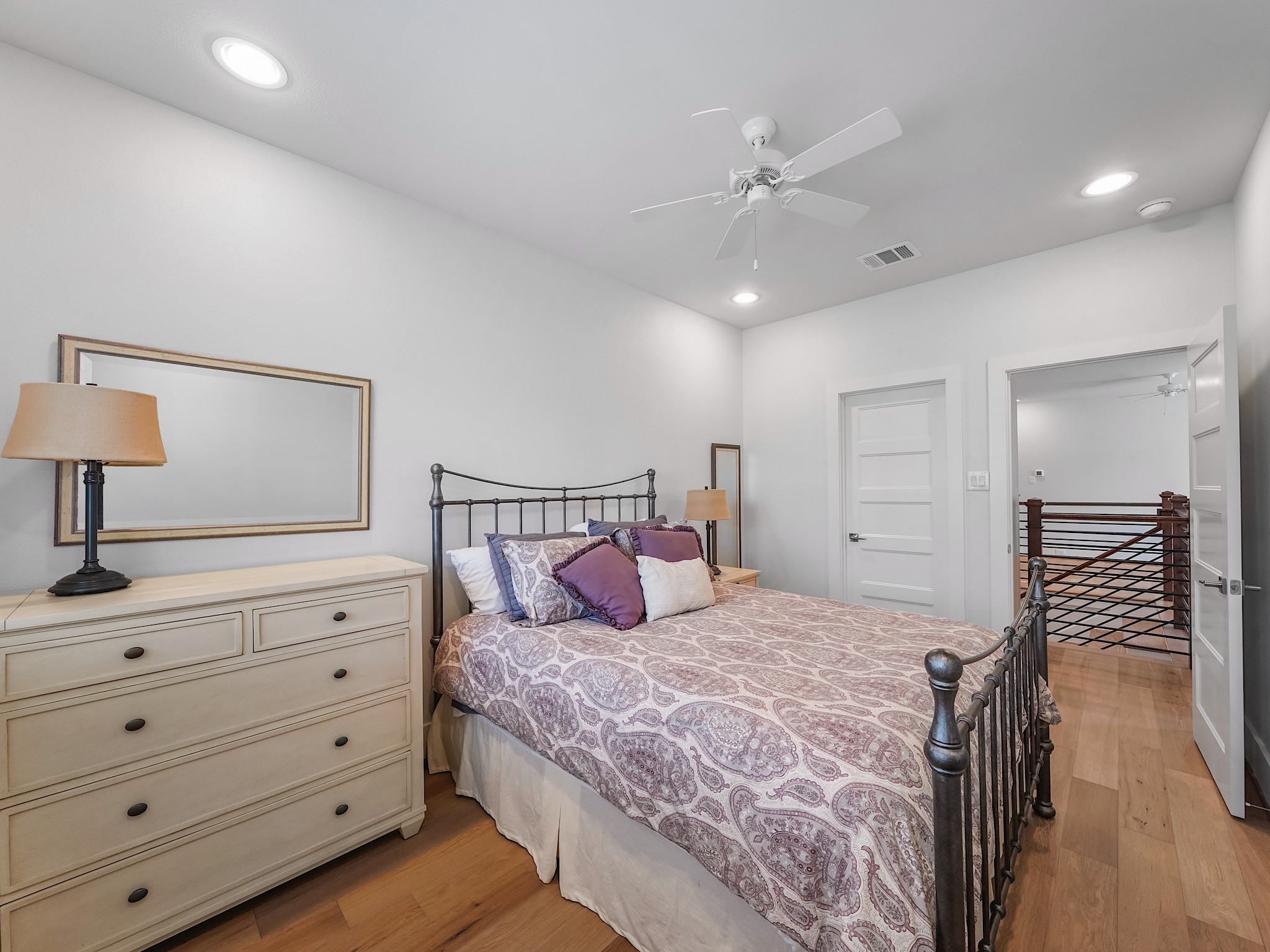 812 East 24th Street Houston, TX 77009 - Photo 30 of 36 a bedroom with a large bed and a chandelier