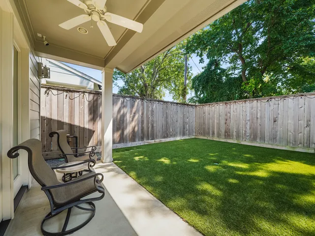 a view of a backyard with chairs