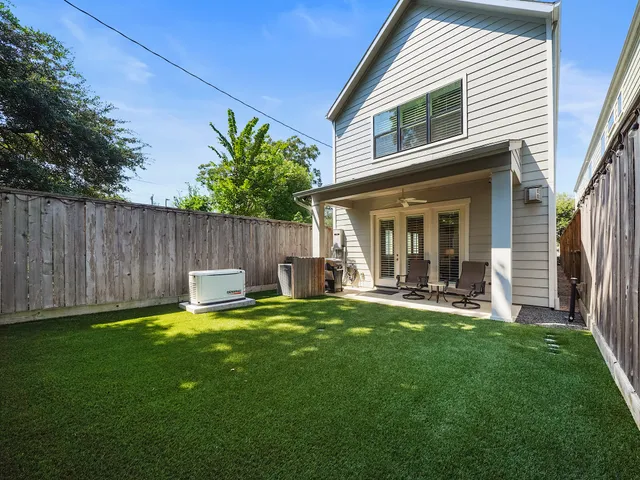 a view of a house with a yard and sitting area