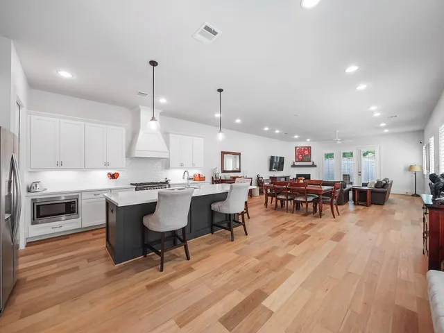 a large kitchen with a table and chairs in it
