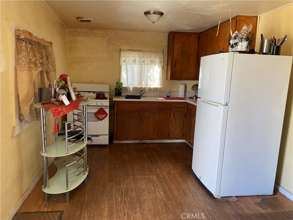 7979 Tyler Street Highland, CA 92346 - Photo 5 of 6 a view of a kitchen with fridge and workspace