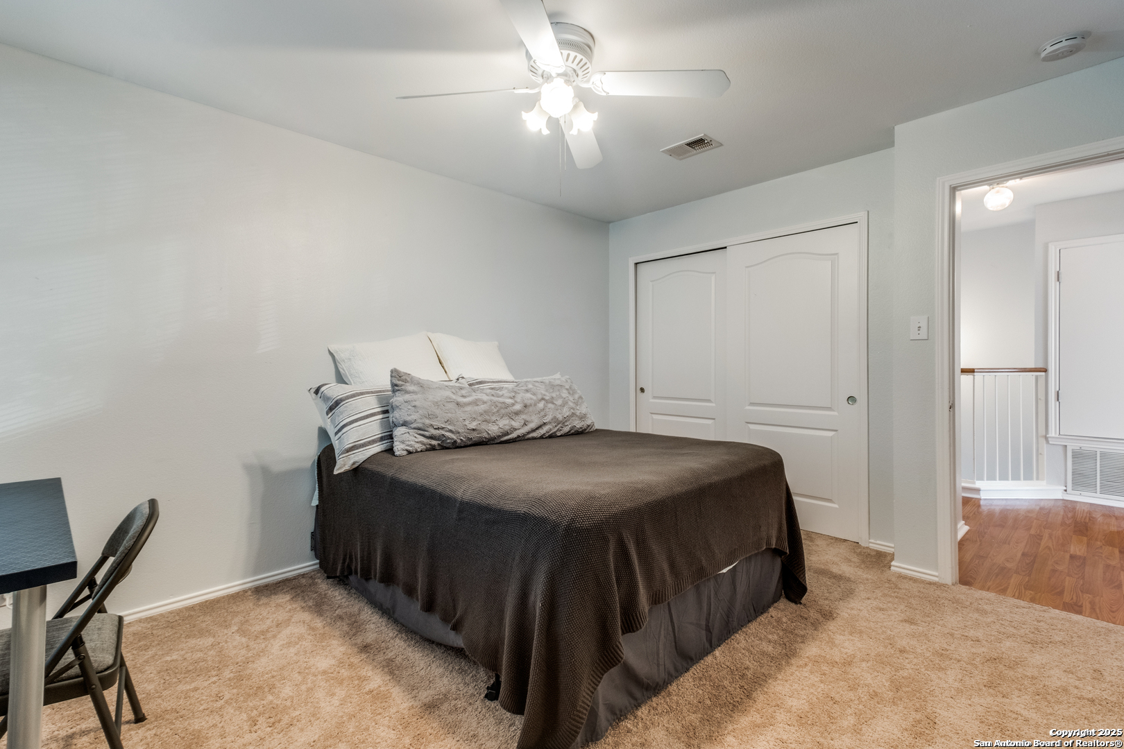 16558 Redland Ranch San Antonio, TX 78247 - Photo 11 of 15 a bedroom with a bed and a chandelier