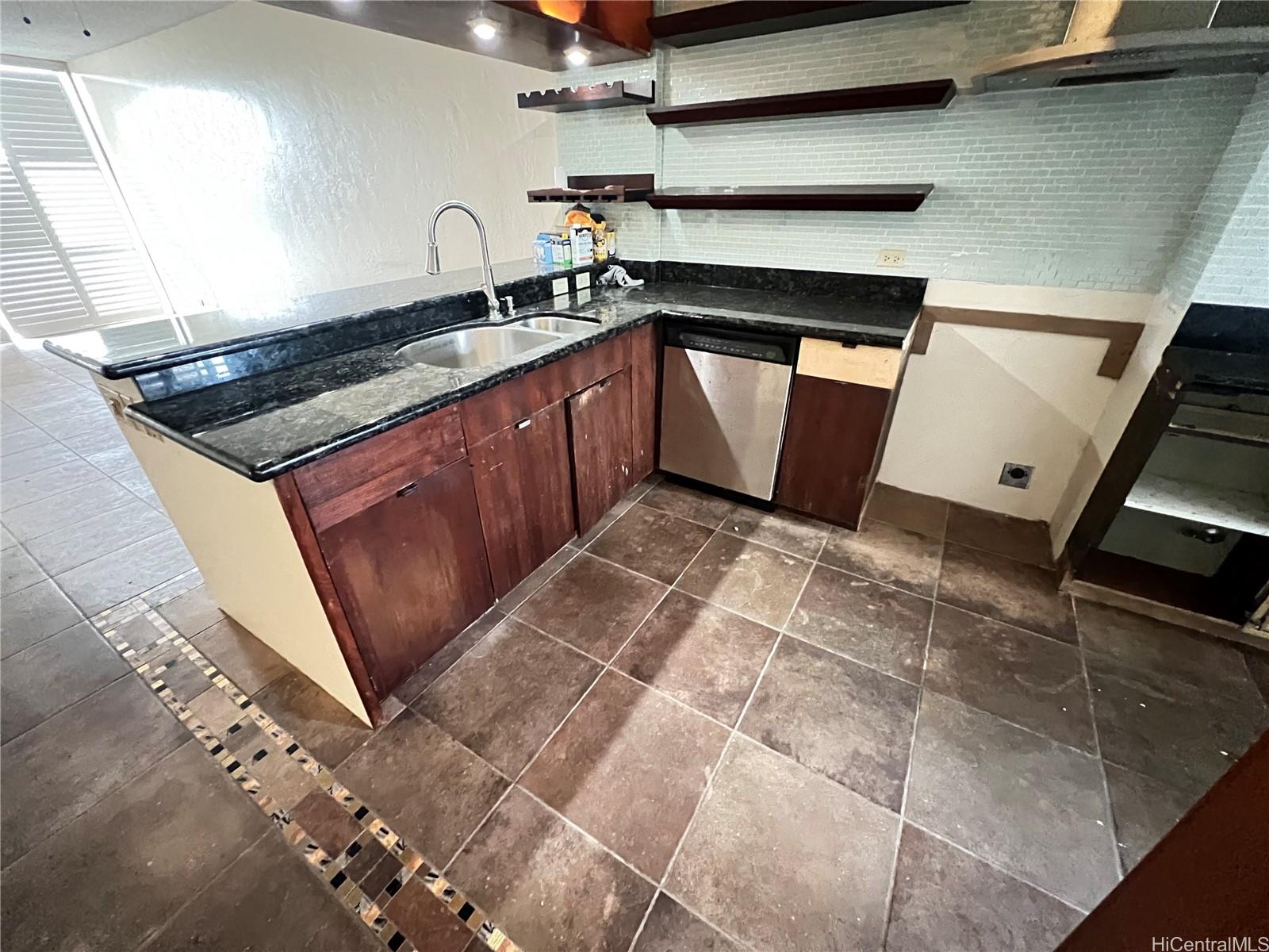500 Lunalilo Home Road, Unit 18C Honolulu, HI 96825 - Photo 5 of 22 a kitchen with granite countertop a sink a stove and cabinets