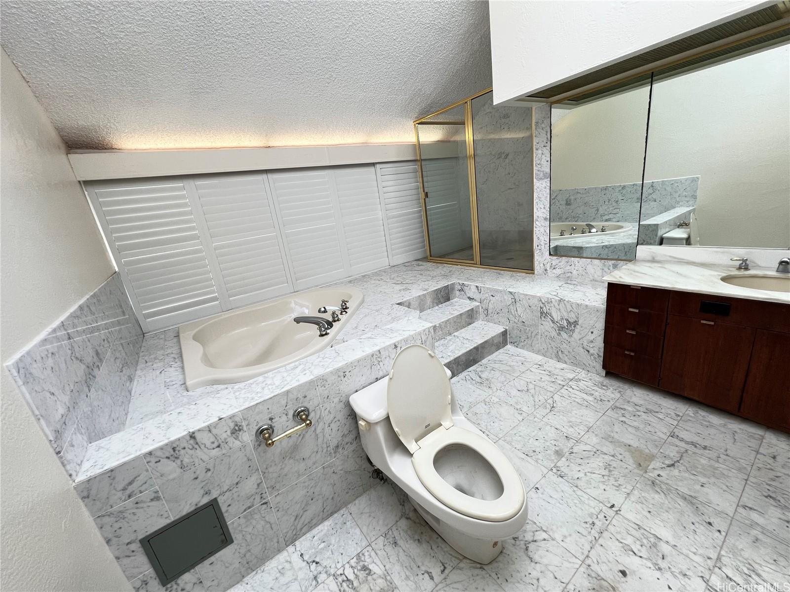 500 Lunalilo Home Road, Unit 18C Honolulu, HI 96825 - Photo 8 of 22 a bathroom with a granite countertop sink toilet and shower