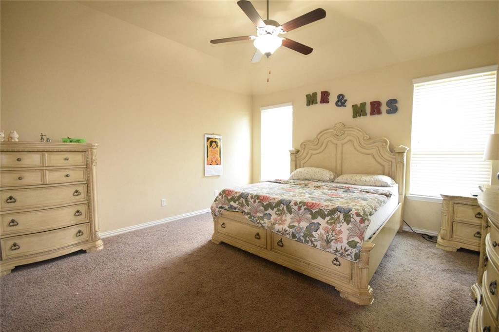 12421 Hitch Rack Way McKinney, TX 75071 - Photo 6 of 21 a bedroom with a bed and a chandelier