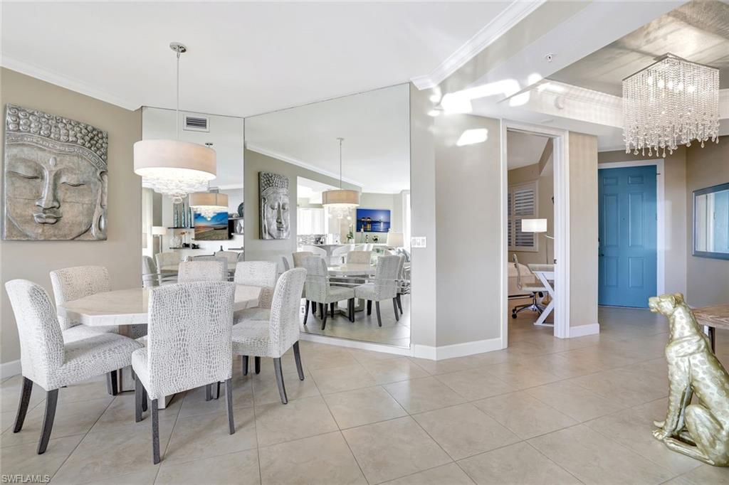 400 Flagship Drive, Unit 602 Naples, FL 34108 - Photo 11 of 37 a view of a dining room and livingroom with furniture wooden floor a chandelier