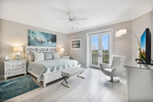 a spacious bedroom with a bed and a flat screen tv