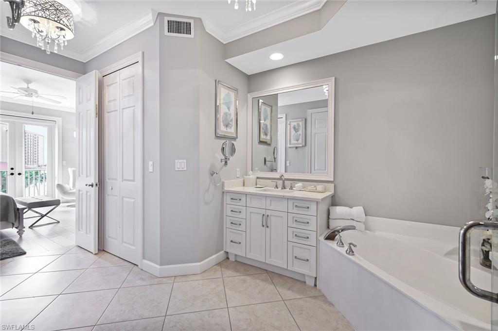 400 Flagship Drive, Unit 602 Naples, FL 34108 - Photo 15 of 37 a bathroom with a bathtub shower and a sink