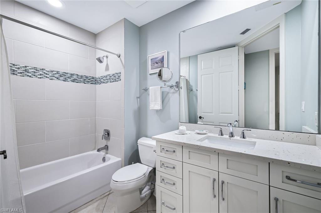 400 Flagship Drive, Unit 602 Naples, FL 34108 - Photo 19 of 37 a bathroom with a sink a toilet and a mirror