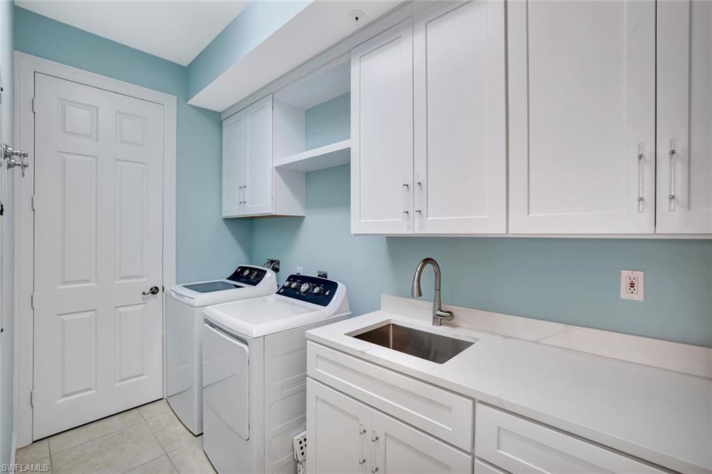 400 Flagship Drive, Unit 602 Naples, FL 34108 - Photo 22 of 37 a kitchen with white cabinets and white appliances