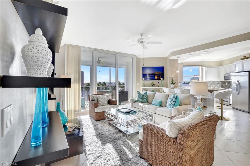 400 Flagship Drive, Unit 602 Naples, FL 34108 - Photo 4 of 37 a living room with furniture wooden floor and a rug