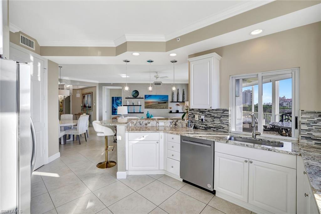 400 Flagship Drive, Unit 602 Naples, FL 34108 - Photo 8 of 37 a kitchen with appliances a sink a counter top space and cabinets
