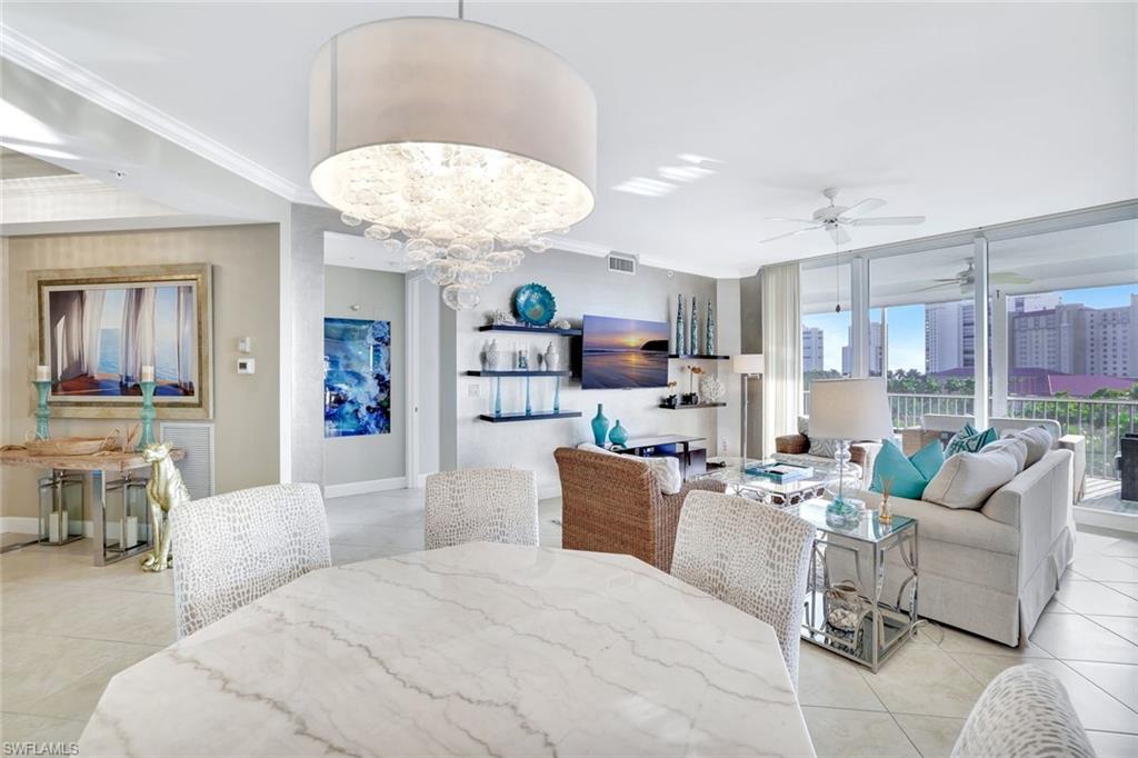 400 Flagship Drive, Unit 602 Naples, FL 34108 - Photo 10 of 37 a large bedroom with furniture and a chandelier