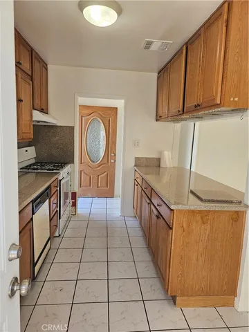 a kitchen with stainless steel appliances a stove a sink and a microwave